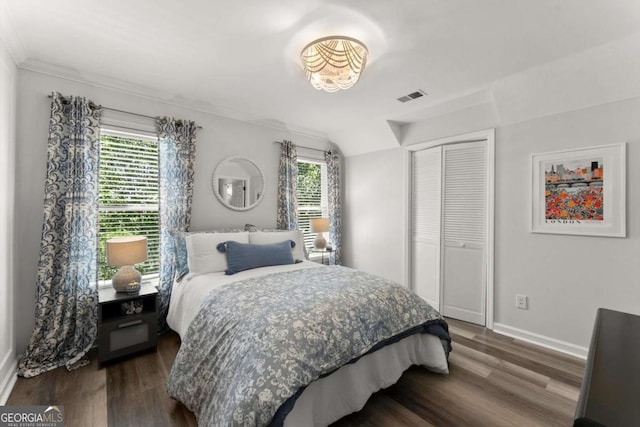 2936 Summitop Rd NE, Marietta, GA 30066 - bedroom featuring multiple windows, dark wood-style floors, a closet, and ornamental molding