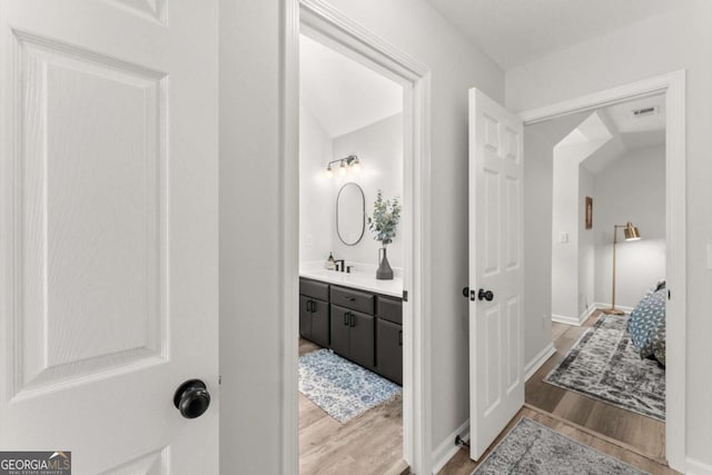 2936 Summitop Rd NE, Marietta, GA 30066 - bathroom with wood finished floors, vanity, and baseboards