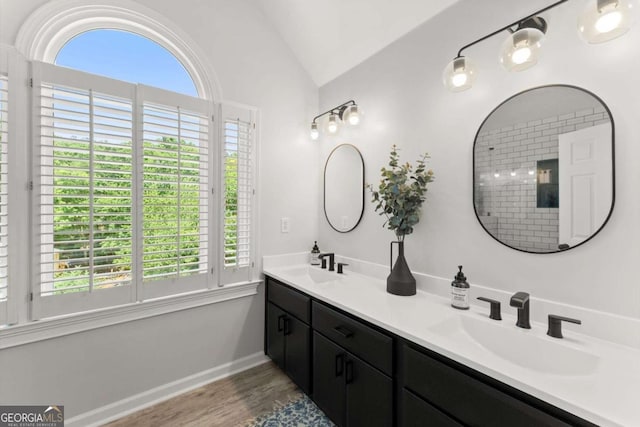 2936 Summitop Rd NE, Marietta, GA 30066 - full bathroom featuring double vanity, lofted ceiling, wood finished floors, and baseboards