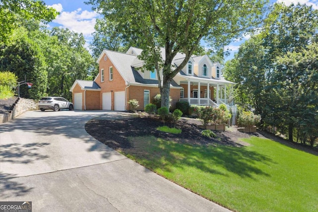 2936 Summitop Rd NE, Marietta, GA 30066 - cape cod-style house featuring covered porch, a front lawn, driveway, and brick siding