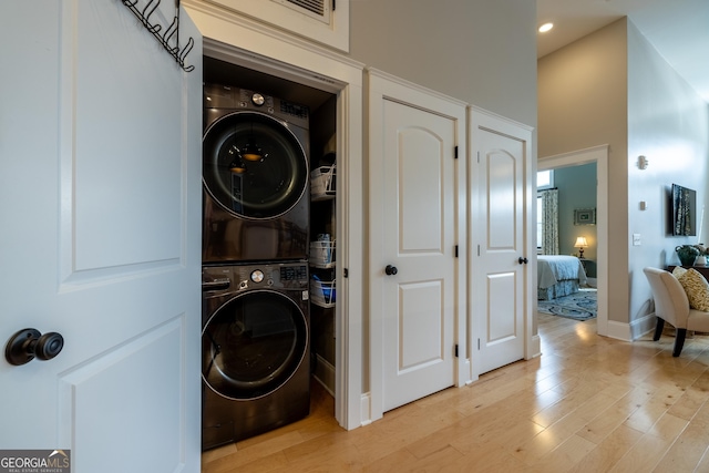 1 E 3rd Ave Unit 302, Rome, GA 30161 - laundry room with stacked washing machine and dryer, light wood-style floors, recessed lighting, and baseboards