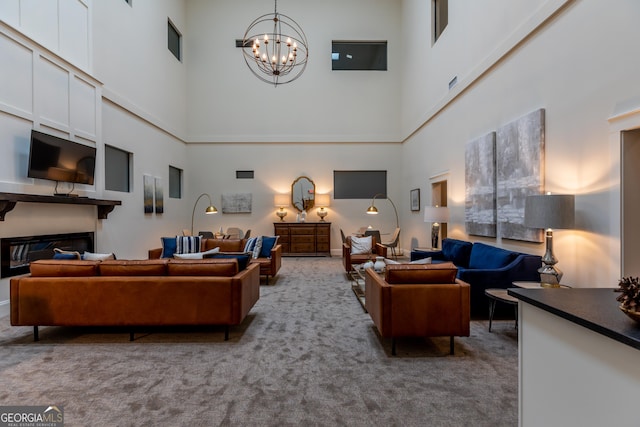 1 E 3rd Ave Unit 302, Rome, GA 30161 - living room with a high ceiling, a chandelier, carpet flooring, and a glass covered fireplace