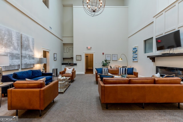 1 E 3rd Ave Unit 302, Rome, GA 30161 - living area with carpet flooring, a chandelier, a towering ceiling, and a glass covered fireplace