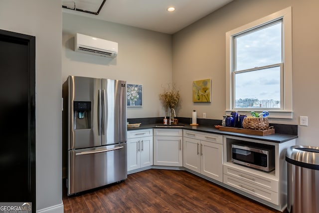 1 E 3rd Ave Unit 302, Rome, GA 30161 - kitchen featuring stainless steel appliances, a wall unit AC, dark countertops, dark wood-style flooring, and recessed lighting
