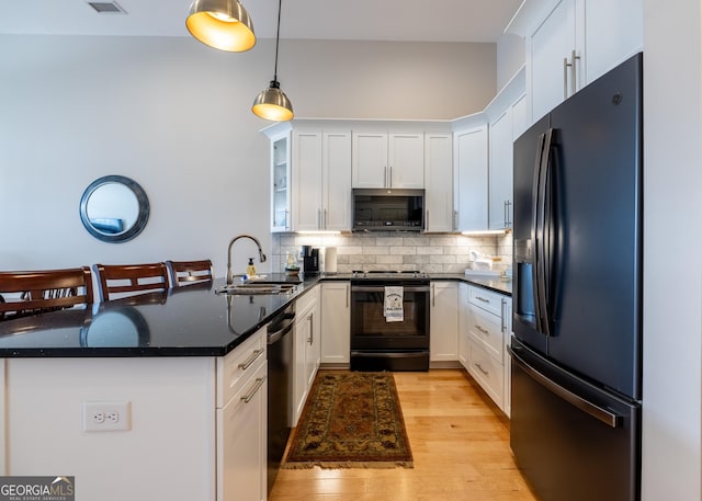1 E 3rd Ave Unit 302, Rome, GA 30161 - kitchen with black appliances, a peninsula, white cabinetry, a sink, and backsplash