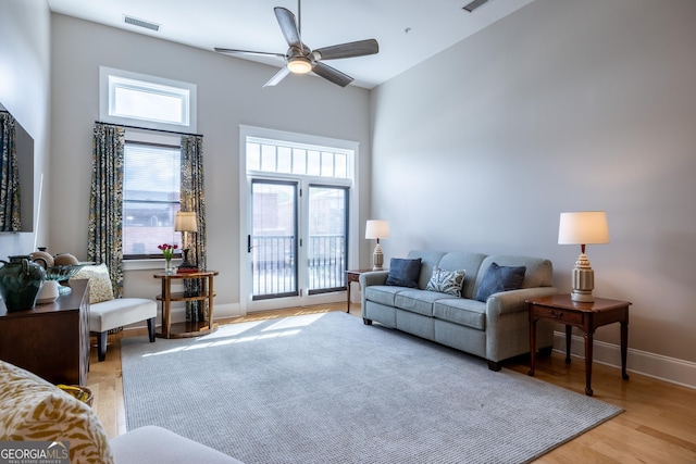 1 E 3rd Ave Unit 302, Rome, GA 30161 - living area featuring baseboards, a ceiling fan, a towering ceiling, and light wood-style flooring