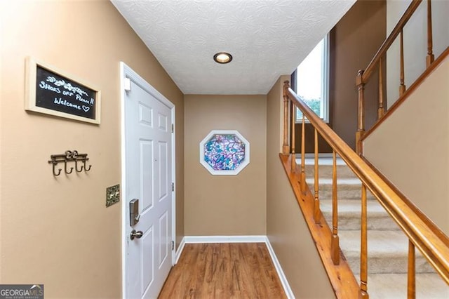 916 Forest Pointe Way, Jonesboro, GA 30238 - entryway featuring wood finished floors, baseboards, stairway, and a textured ceiling