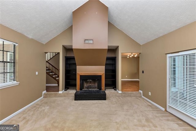 916 Forest Pointe Way, Jonesboro, GA 30238 - unfurnished living room featuring a textured ceiling, baseboards, carpet flooring, stairs, and built in features