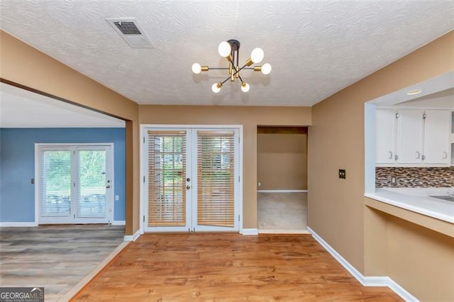 916 Forest Pointe Way, Jonesboro, GA 30238 - entryway with a chandelier, light wood-type flooring, and baseboards