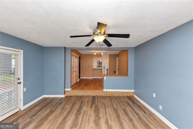 916 Forest Pointe Way, Jonesboro, GA 30238 - unfurnished living room with baseboards, wood finished floors, ceiling fan, and a textured ceiling