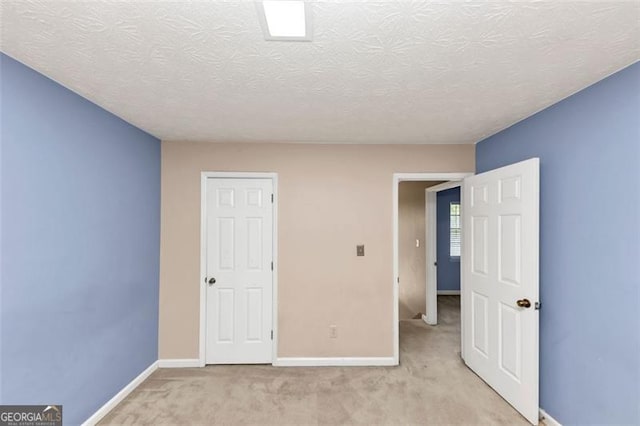 916 Forest Pointe Way, Jonesboro, GA 30238 - unfurnished bedroom with light colored carpet, baseboards, and a textured ceiling