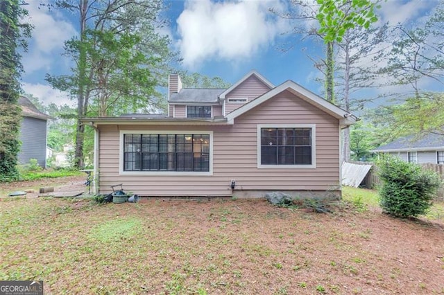 916 Forest Pointe Way, Jonesboro, GA 30238 - rear view of property with a chimney