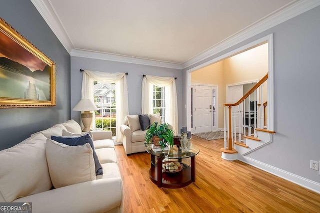 2484 Mossy Branch Dr, Snellville, GA 30078 - living area featuring ornamental molding, wood finished floors, stairs, and baseboards