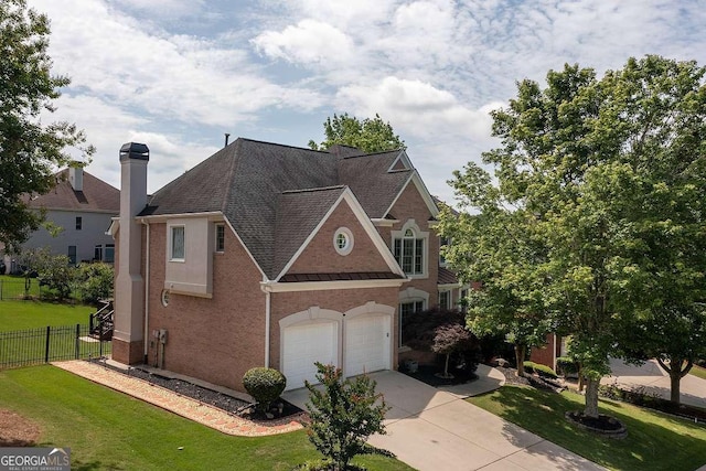 2484 Mossy Branch Dr, Snellville, GA 30078 - view of front facade featuring roof with shingles, driveway, a garage, and a chimney