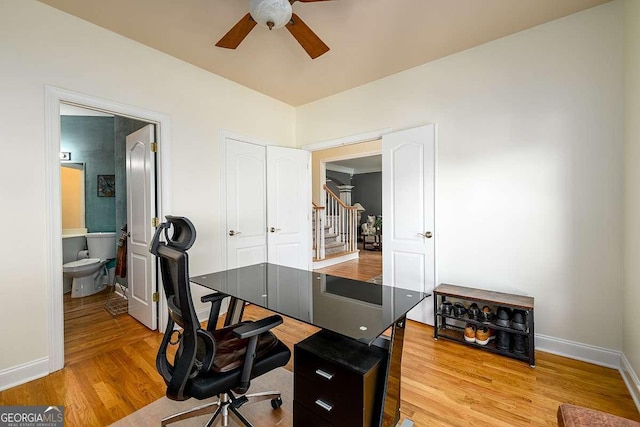 2484 Mossy Branch Dr, Snellville, GA 30078 - home office featuring ceiling fan, baseboards, and light wood-style floors