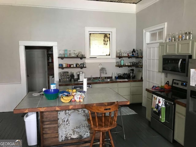 1432 Calhoun St, Macon, GA 31201 - kitchen featuring stainless steel appliances, dark wood finished floors, crown molding, open shelves, and a breakfast bar