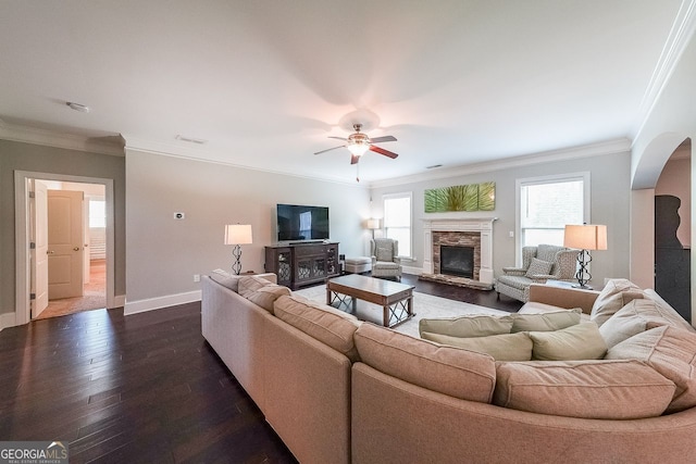 265 Enfield Ln, Mcdonough, GA 30252 - living area featuring arched walkways, ceiling fan, dark wood-style flooring, a fireplace, and ornamental molding
