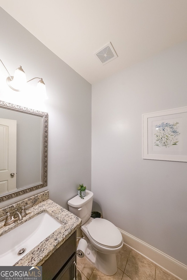 265 Enfield Ln, Mcdonough, GA 30252 - half bathroom featuring vanity, toilet, tile patterned floors, and baseboards