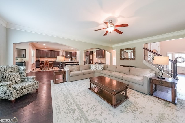 265 Enfield Ln, Mcdonough, GA 30252 - living area featuring arched walkways, crown molding, a ceiling fan, wood-type flooring, and stairway