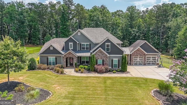 265 Enfield Ln, Mcdonough, GA 30252 - craftsman house featuring stone siding, concrete driveway, an outdoor structure, a front lawn, and a garage