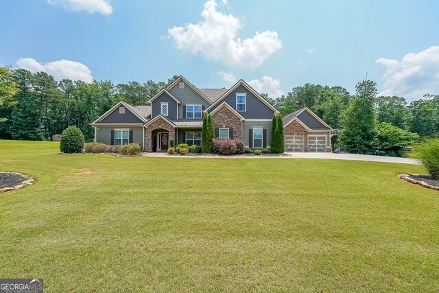265 Enfield Ln, Mcdonough, GA 30252 - craftsman house with stone siding, a front lawn, concrete driveway, and a garage