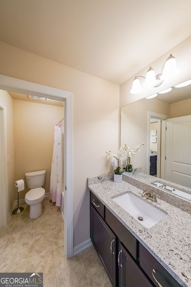 265 Enfield Ln, Mcdonough, GA 30252 - full bath with vanity, toilet, baseboards, and tile patterned flooring