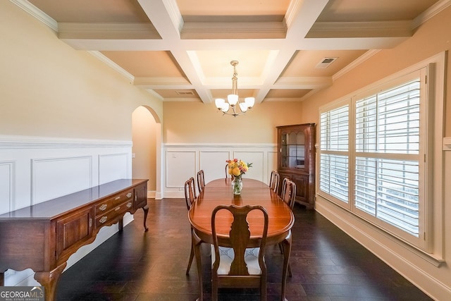 265 Enfield Ln, Mcdonough, GA 30252 - dining space with a chandelier, arched walkways, beamed ceiling, coffered ceiling, and dark wood-style floors