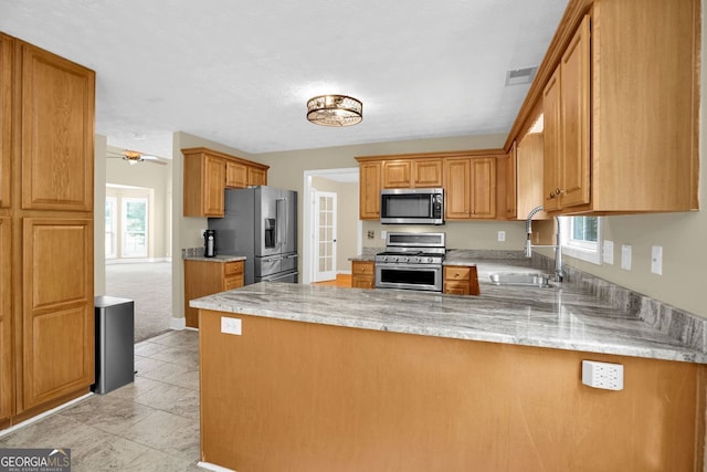 4000 Mcpherson Dr, Acworth, GA 30101 - kitchen featuring stainless steel appliances, a peninsula, and brown cabinets