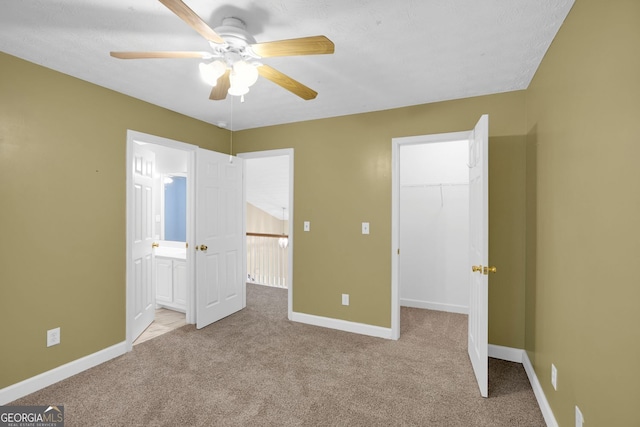 4000 Mcpherson Dr, Acworth, GA 30101 - unfurnished bedroom with carpet, a walk in closet, a closet, a ceiling fan, and ensuite bathroom