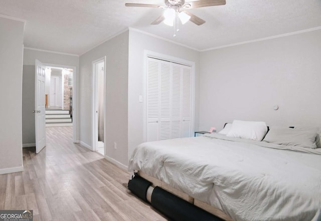 435 Goss Rd, Epworth, GA 30541 - bedroom with light wood-type flooring, a closet, a textured ceiling, baseboards, and crown molding