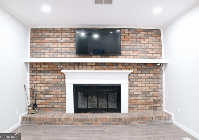 435 Goss Rd, Epworth, GA 30541 - detailed view of a fireplace, wood finished floors, baseboards, recessed lighting, and crown molding
