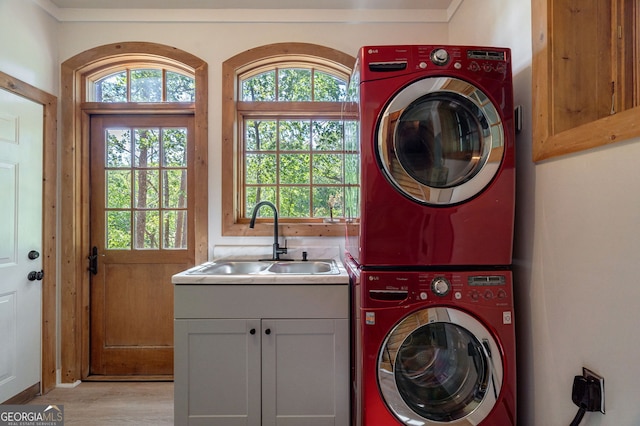 4317 Harold Whelchel Rd, Gainesville, GA 30506 - laundry area featuring stacked washer and clothes dryer, cabinet space, plenty of natural light, and light wood-type flooring