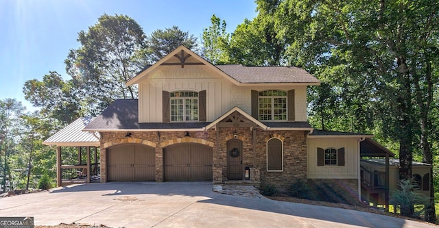 4317 Harold Whelchel Rd, Gainesville, GA 30506 - view of front facade featuring stone siding, concrete driveway, board and batten siding, a shingled roof, and an attached garage