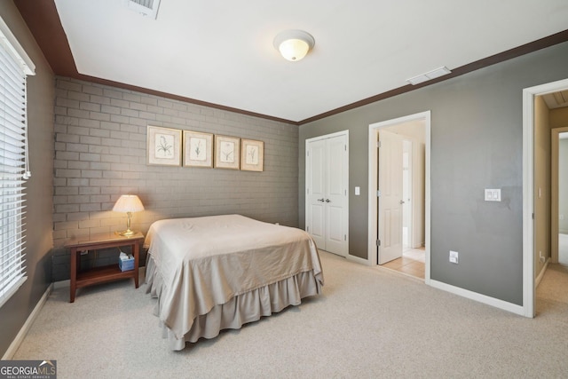 2871 Trailing Ivy Way, Buford, GA 30519 - bedroom with brick wall, light colored carpet, a closet, and multiple windows