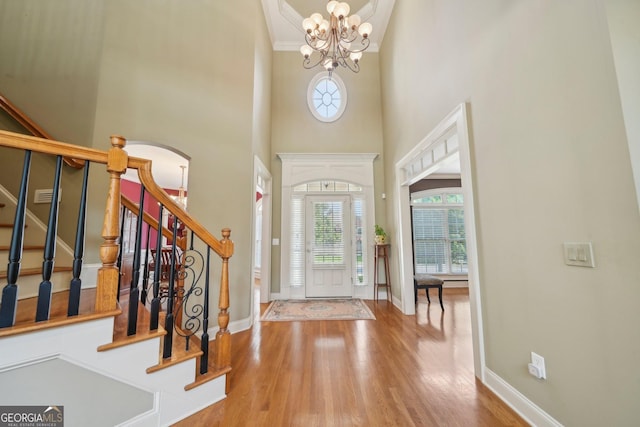 2871 Trailing Ivy Way, Buford, GA 30519 - entrance foyer featuring wood finished floors, stairway, a towering ceiling, and a chandelier