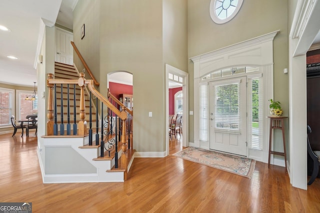 2871 Trailing Ivy Way, Buford, GA 30519 - entrance foyer with wood finished floors, arched walkways, stairway, a towering ceiling, and recessed lighting