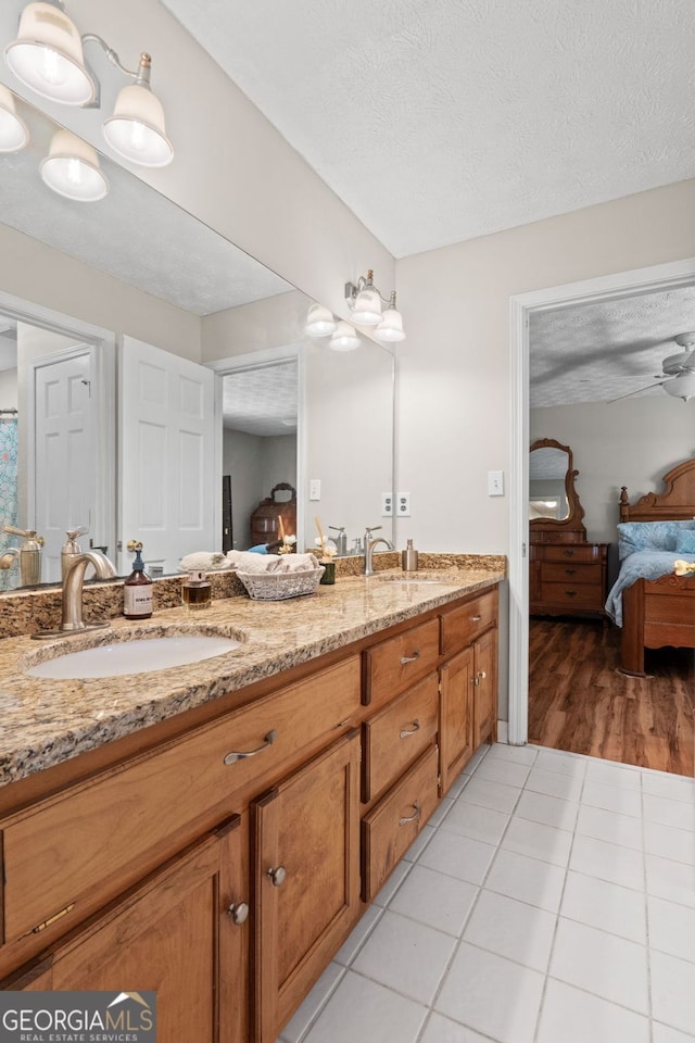 401 Riverwalk, Mcdonough, GA 30252 - ensuite bathroom with double vanity, a textured ceiling, and tile patterned flooring