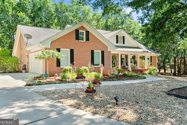 401 Riverwalk, Mcdonough, GA 30252 - view of front of home with covered porch, brick siding, a garage, concrete driveway, and a shingled roof