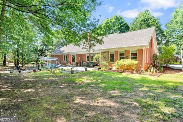401 Riverwalk, Mcdonough, GA 30252 - back of house with a patio area, brick siding, a shingled roof, and a chimney