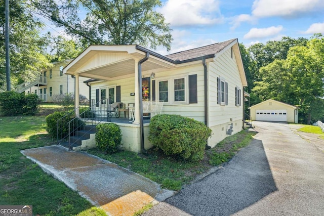 954 Bryant St SW, Conyers, GA 30012 - view of front of property featuring covered porch, an outbuilding, a detached garage, and french doors