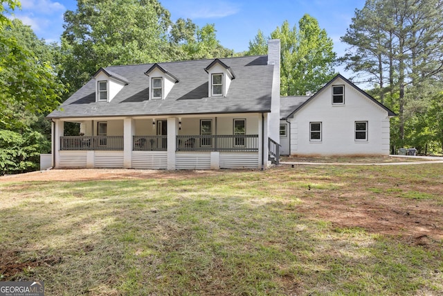 1143 Mcgarity Rd, Mcdonough, GA 30252 - cape cod-style house featuring a chimney, a front lawn, and covered porch