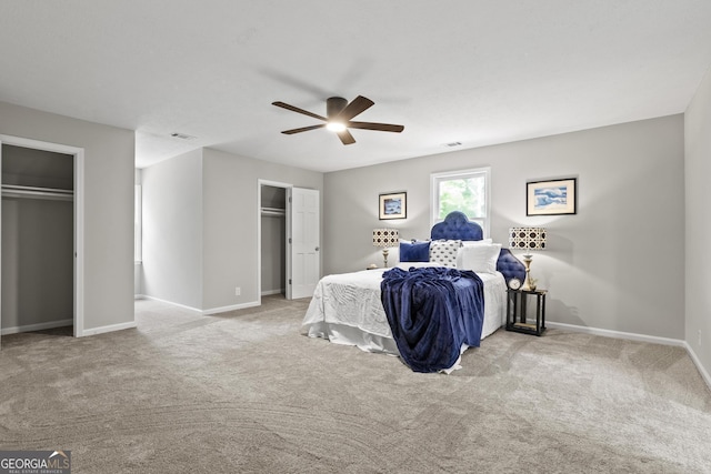 1143 Mcgarity Rd, Mcdonough, GA 30252 - carpeted bedroom with multiple closets, baseboards, and ceiling fan