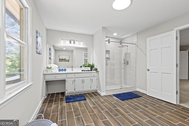 1143 Mcgarity Rd, Mcdonough, GA 30252 - bathroom featuring vanity, a shower stall, baseboards, wood finished floors, and recessed lighting