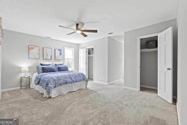 1143 Mcgarity Rd, Mcdonough, GA 30252 - bedroom with two closets, carpet floors, baseboards, and ceiling fan