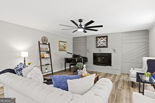 1143 Mcgarity Rd, Mcdonough, GA 30252 - living area with ceiling fan, wood finished floors, crown molding, and a brick fireplace