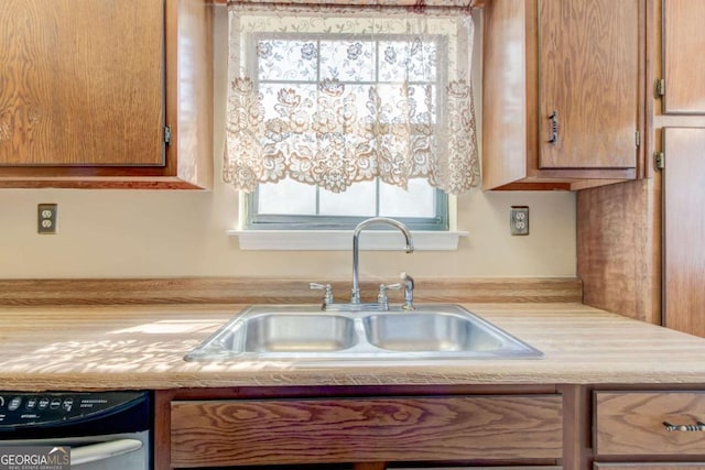 2211 Jonathan Ave, Lithonia, GA 30058 - kitchen featuring dishwashing machine, light countertops, and brown cabinets
