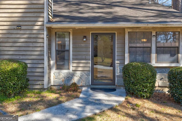 2211 Jonathan Ave, Lithonia, GA 30058 - view of exterior entry with roof with shingles and stone siding