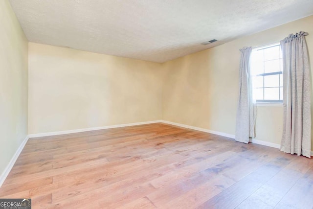 2211 Jonathan Ave, Lithonia, GA 30058 - unfurnished room with light wood-style floors and a textured ceiling