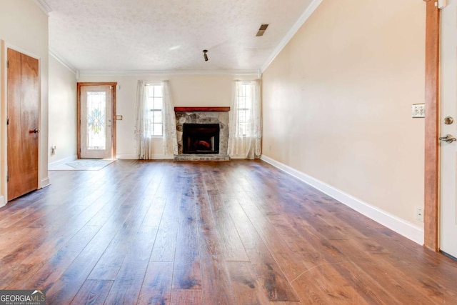 2211 Jonathan Ave, Lithonia, GA 30058 - unfurnished living room featuring hardwood / wood-style flooring, ornamental molding, a fireplace, and a textured ceiling