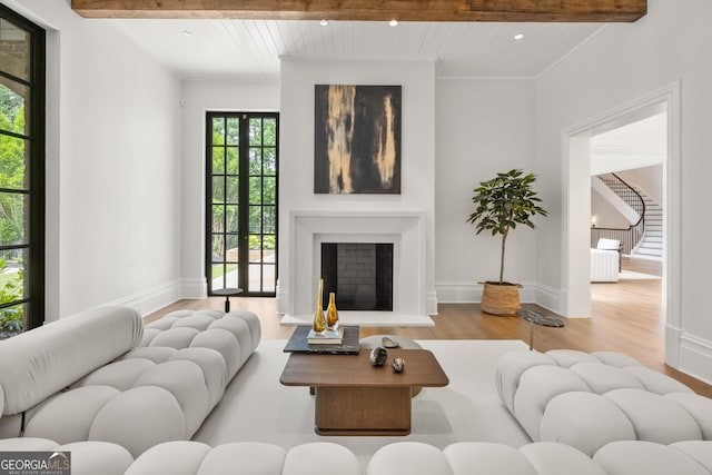 4560 Harris Trl, Atlanta, GA 30327 - living area with wood finished floors, beamed ceiling, recessed lighting, a fireplace with raised hearth, and baseboards